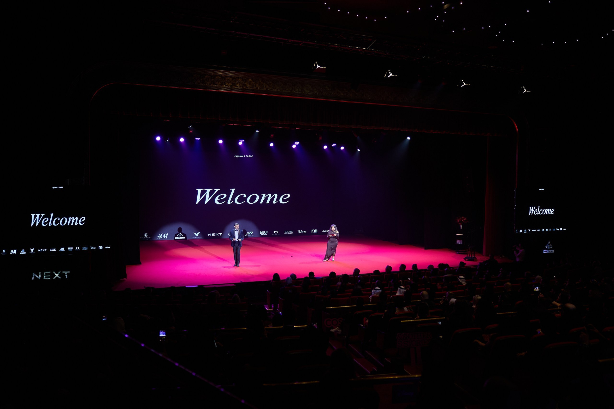Wide view of a corporate event stage and audience during professional event coverage in Dubai