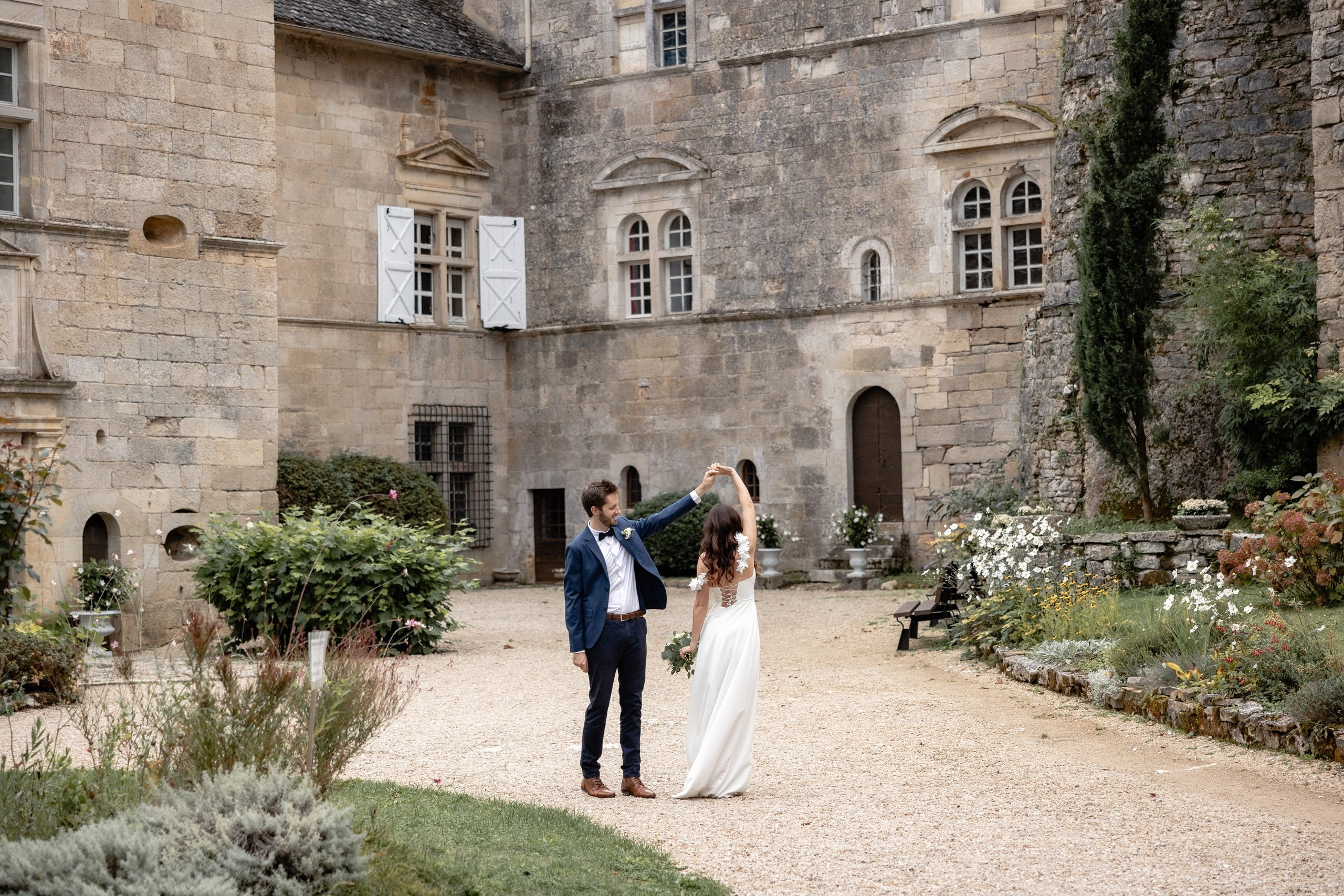 Couple dancing in the gardens at Château de Cénevières during their elopement