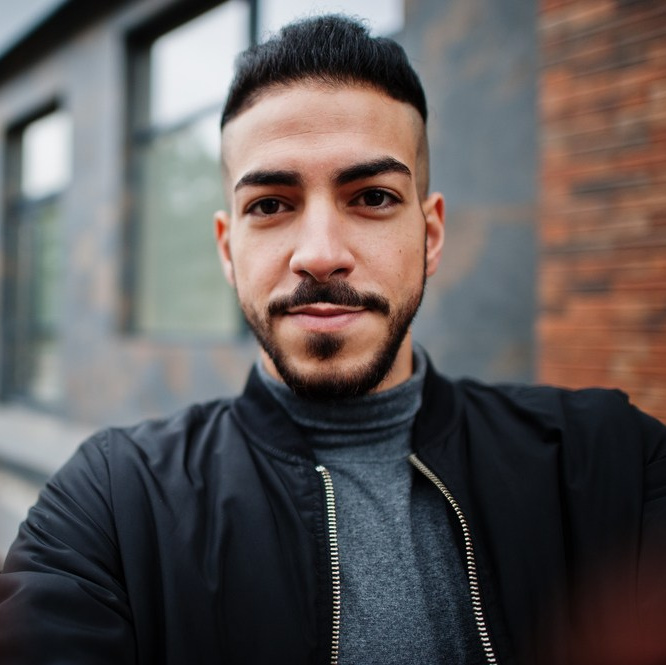 Portrait of a man in a black jacket and turtleneck, looking into the camera