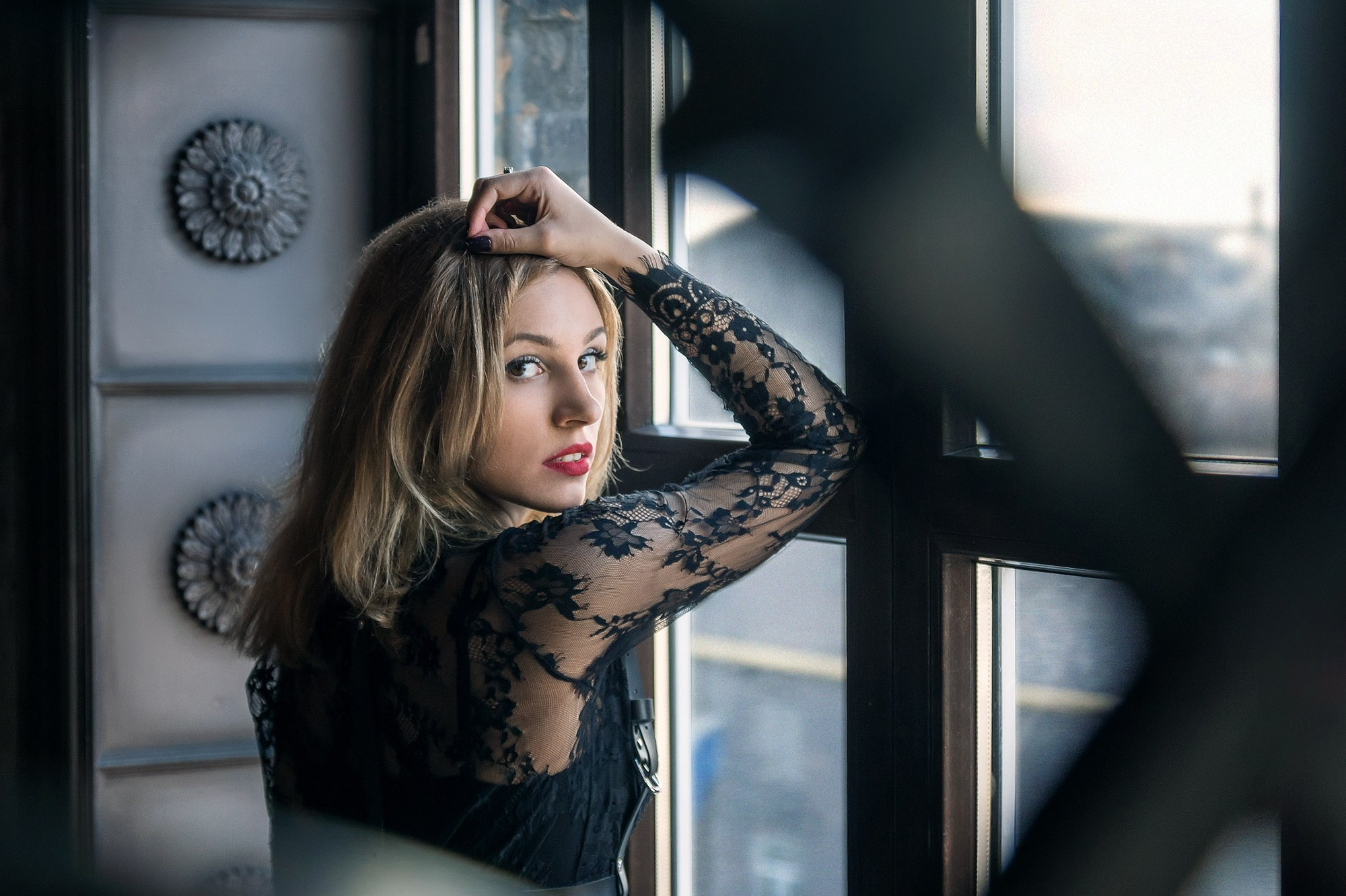 Elegant woman in a black dress gently looking at the viewer, commercial advertisement photo in New Jersey