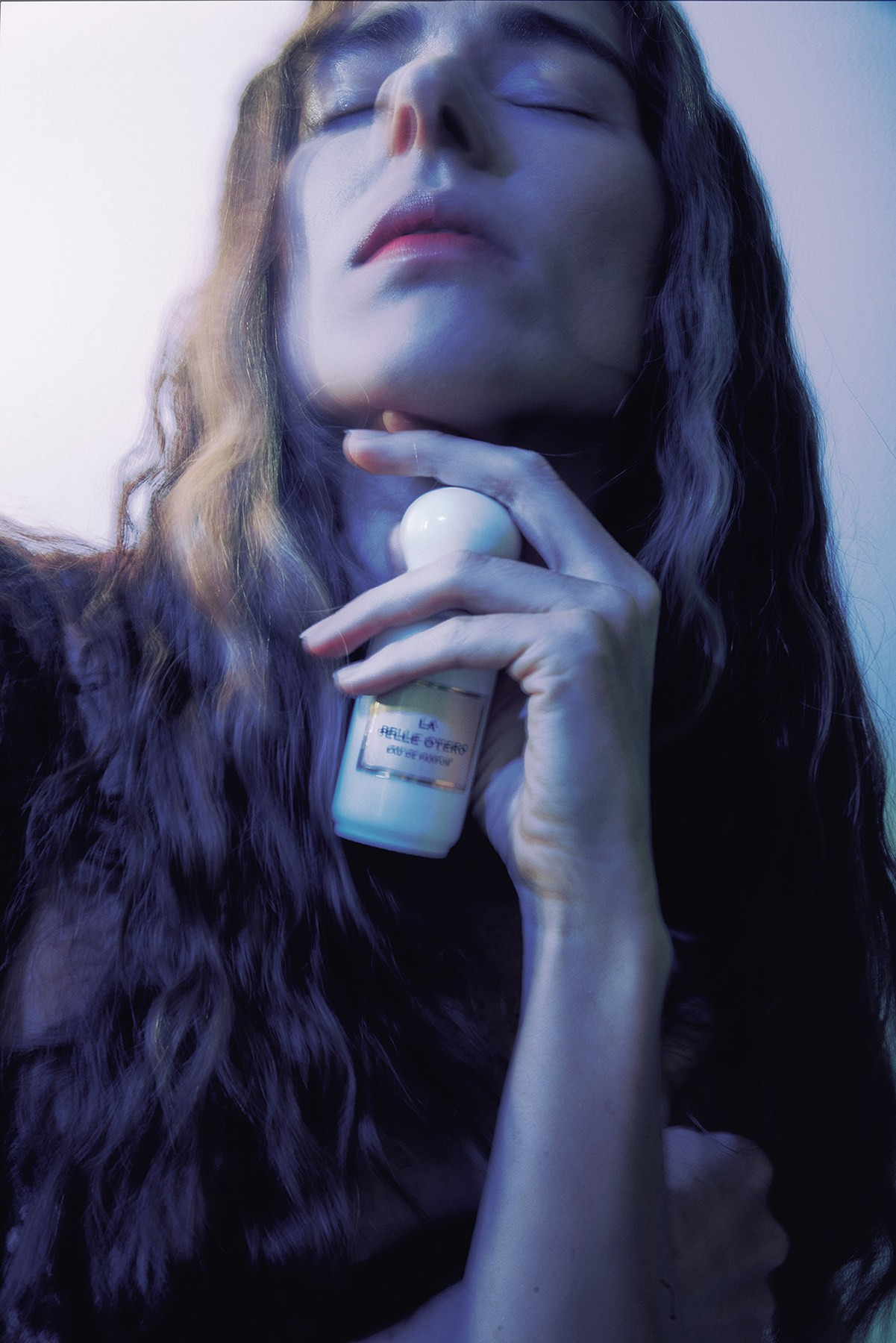 Conceptual shot blending a niche perfume bottle with archival fashion collections. Ambra x The Archivast Collaboration. International creative commerce photography for global and US fashion brands.