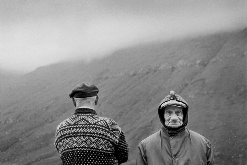 Brothers Fredrikur and Sofus on the island of Eysturoy look out over the water, each in their own direction, near Elduvik village, Runavik municipality, Faroe Islands, Kingdom of Denmark. 1997