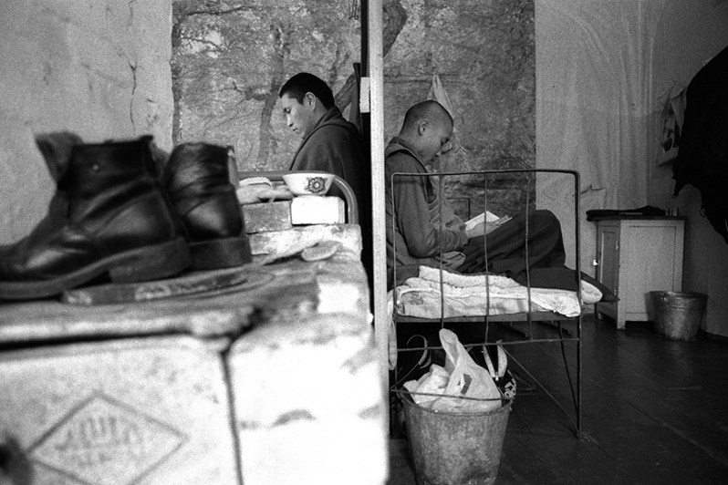 Buddhist monks in their room, claiming to be future lamas continue to study at night, Verkhnyaya Ivolga village, Buryatia, Russia. November 2001