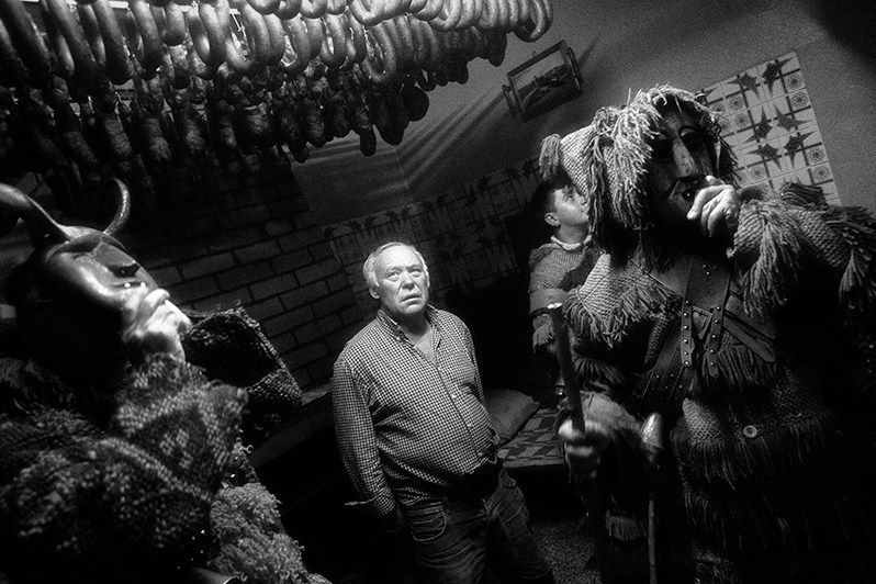 Villager tries to stop the “Caretos” from stealing his chorizos, Bragança municipality, Bragança district, Trás-os-Montes region, Portugal. 2023