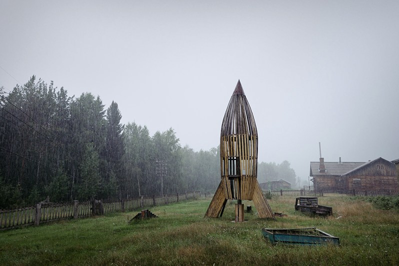 USSR era kindergarten playground with a wooden rocket, Vozhgora village, Leshukonsky district, Arkhangelsk region, Russia. August 2017