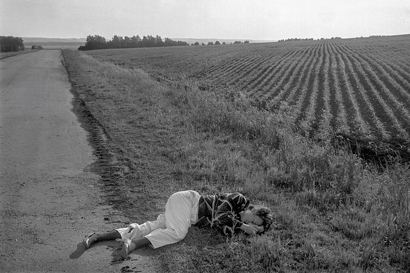 A girl on holiday, asleep in a field by the roadside, Tatar ASSR, Russia, 1991 © Oleg Klimov