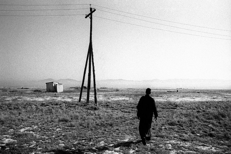 Small white wooden house, one of the complex's toilets, located outside, away from the premises, Verkhnyaya Ivolga village, Buryatia, Russia. November 2001