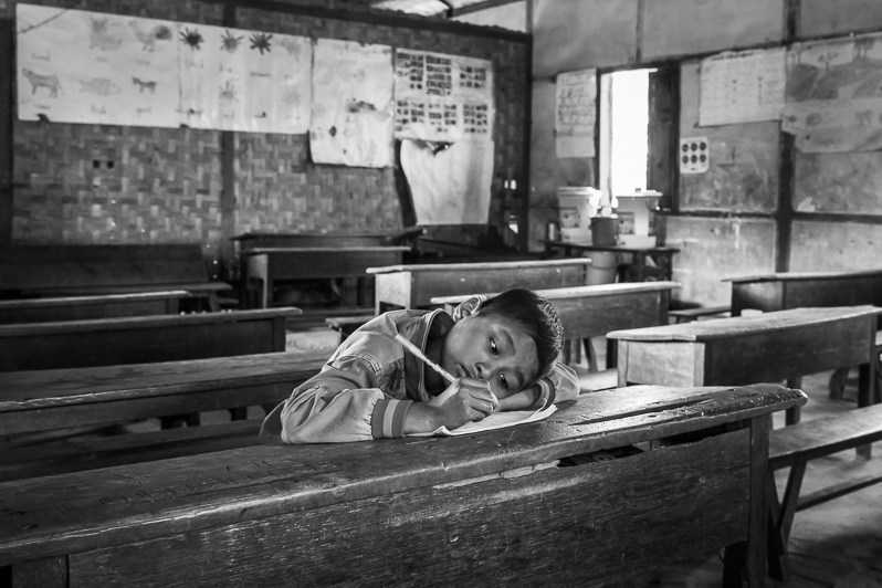 A Kachin boy in the classroom. Robert IDP Camp hosting 4000 internally displaced persons (IDP) of the Christian Kachin Minority, Bhamo township in government controlled territory Myanmar. January 2020
