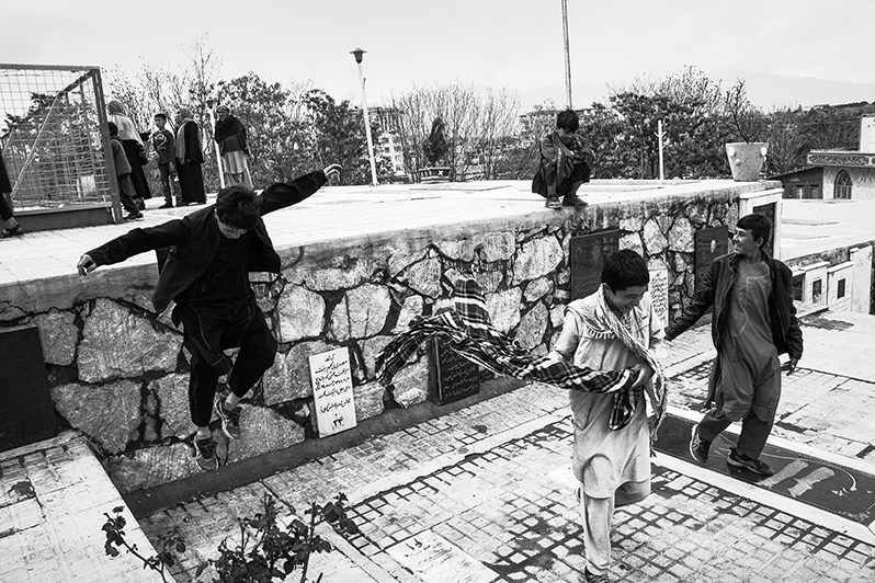 Afghan children spend time in street games, Mazar-e Sakhi road, Kabul, Afghanistan. 2024