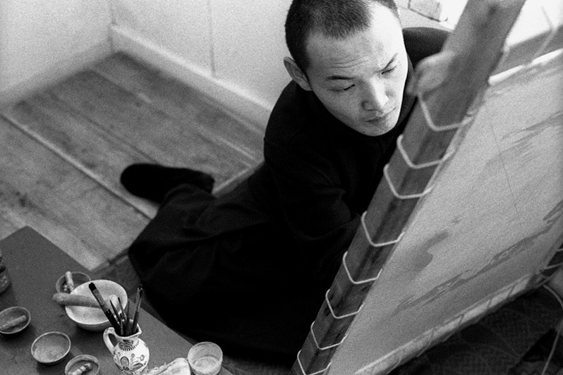 Young Buddhist lama teaches the art of thangka at the Ivolginsky Datsan centre, Verkhnyaya Ivolga village, Buryatia, Russia. November 2001