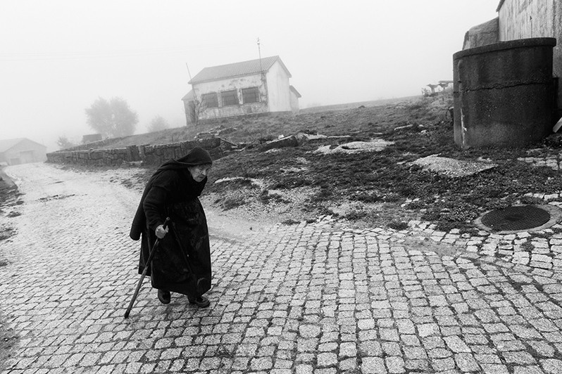 Woman oman wandering on a rustic paving stone, Boticas municipality, Vila Real district, Trás-os-Montes region, Portugal. 2015