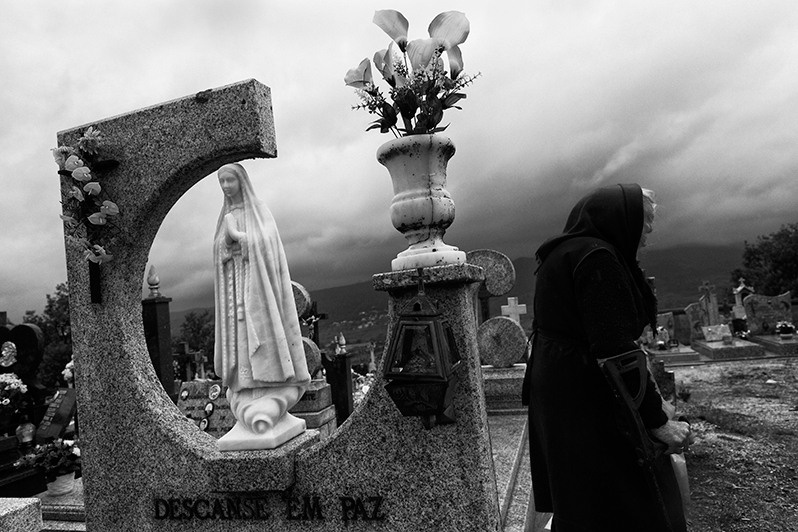 Woman in mourning, wandering through a cemetery, Montalegre municipality, Vila Real district, Trás-os-Montes region, Portugal. 2017
