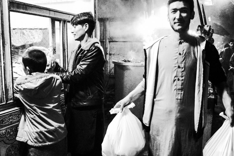 A young Hazara man with shopping, Kabul, Afghanistan. 2024
