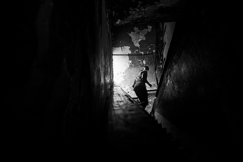 Boy quickly climbs the stairs of a building in the centre of Havana, Centro Habana district, Havana, Cuba. 2020
