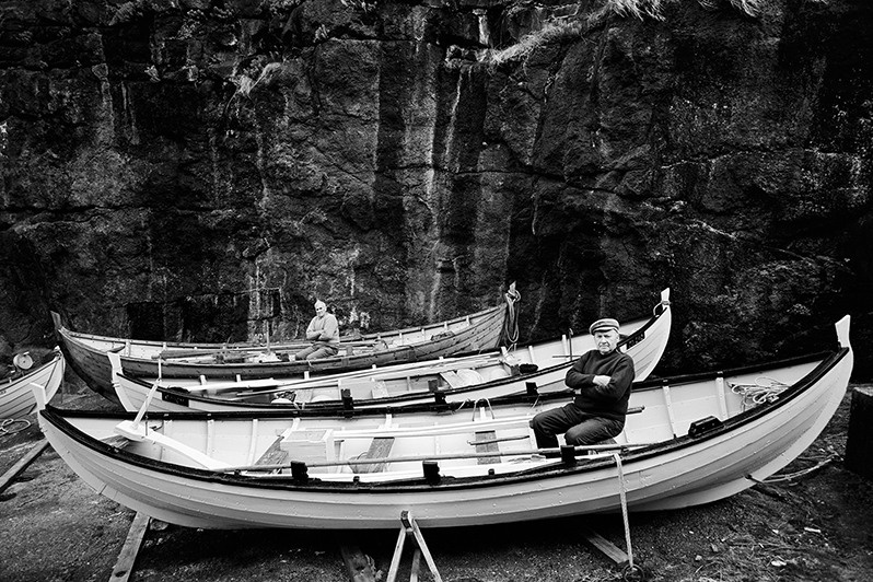 Experienced sailors and fishermen Johannis Sivertsen and Olrik Christiansen pose each in his boat, near Gjógv village, Norðoyar region, Faroe Islands, Kingdom of Denmark. 1998