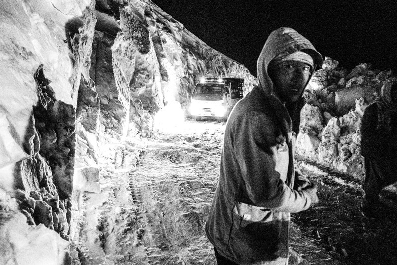 A stalled vehicle on the Hajigak mountain pass covered with snow at an altitude of 3,700 metres, Kohibaba Range, Afghanistan. 2024