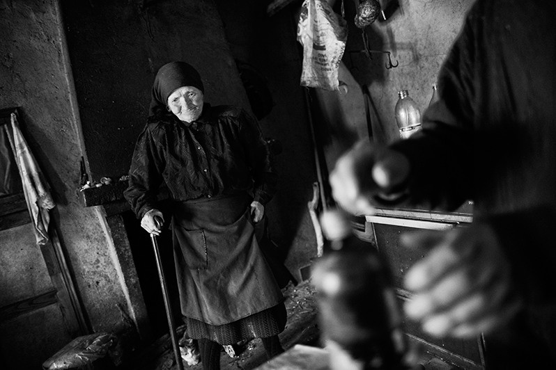 The host brings out a bottle of wine for his guests, Boticas municipality, Vila Real district, Trás-os-Montes region, Portugal. 2016