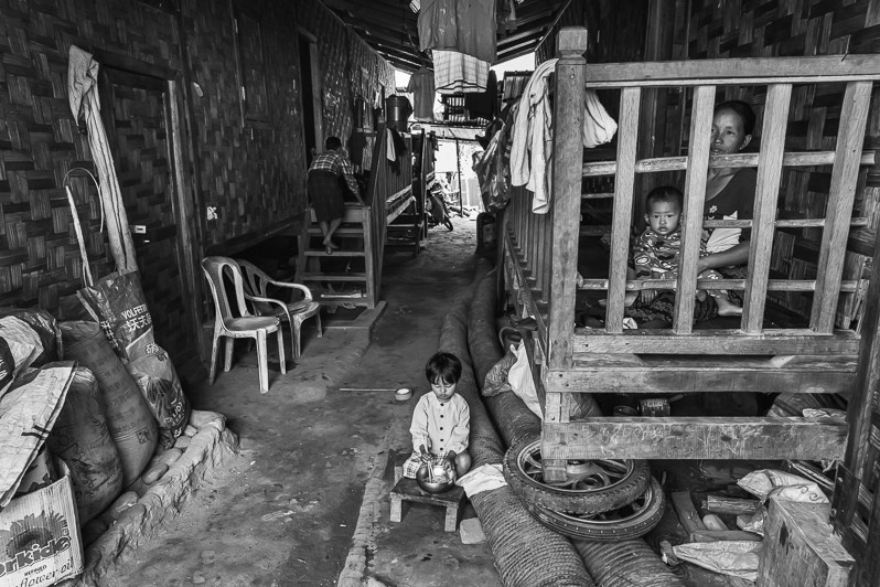 A mother and her children in a camp for internally displaced persons in Kachin Independence Organisation (KIO) held territory, Woichyai IDP camp, Laiza township, Myitkyina district, Kachin state, Myanmar. April 2019