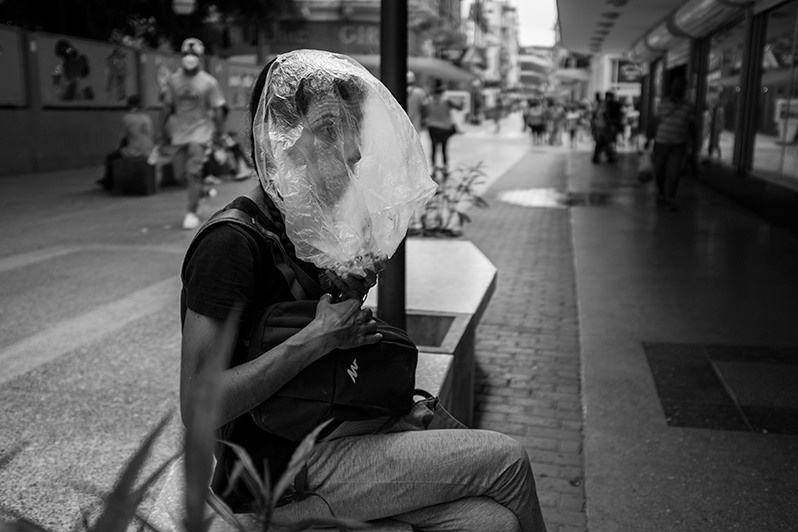 Woman prepares to dine on the street during the Covid-19 pandemic in the centre of Havana, San Rafael street, Centro Habana district, Havana, Cuba. 2021
