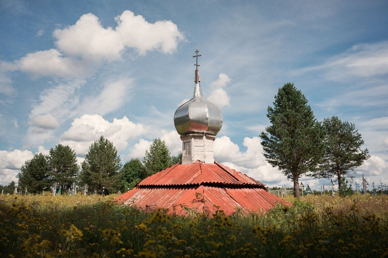 A dome of a destroyed chapel stands in an old rural graveyard, Koptyuga village, Udorsky district, Komi Republic, Russia. 2020