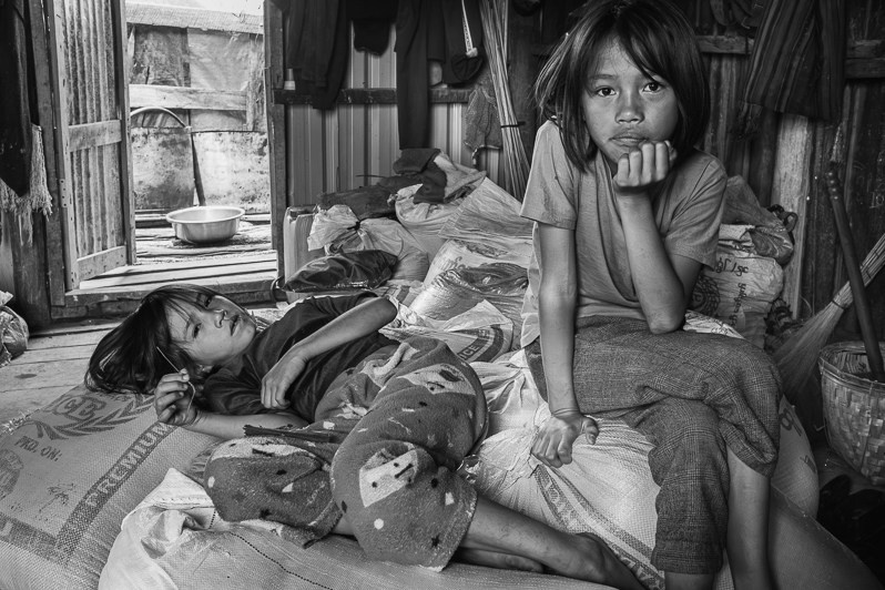 Two sisters displaced from Thantlang, a town that has been totally destroyed, Thangklua village, Chin state, Myanmar. June 2023