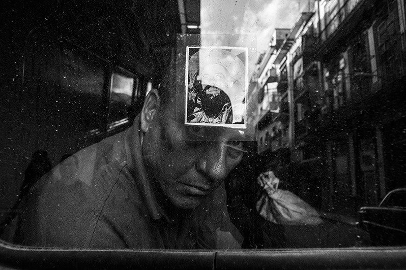 Portrait of a man through a car windscreen, Centro Habana district, Havana, Cuba. 2017
