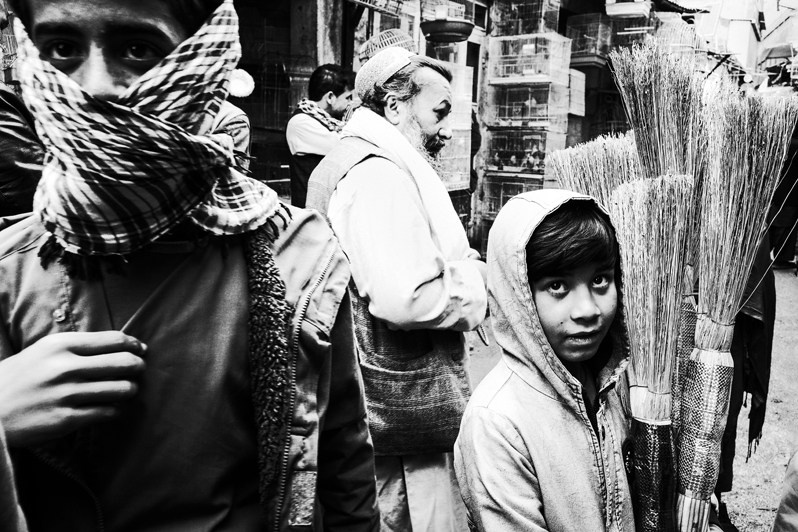 A young broom seller at the Ka Faroshi market, Kabul, Afghanistan. 2024