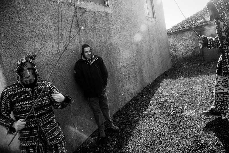 Inhabitant of the village leaning against the wall after being whipped with the “verdascas de negrilho” of the “Caretas”, Bragança municipality, Bragança district, Trás-os-Montes region, Portugal. 2019