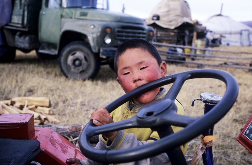 The boy and the machinery, Tsagaan-Üür district, Khövsgöl province, Mongolia. October 2010