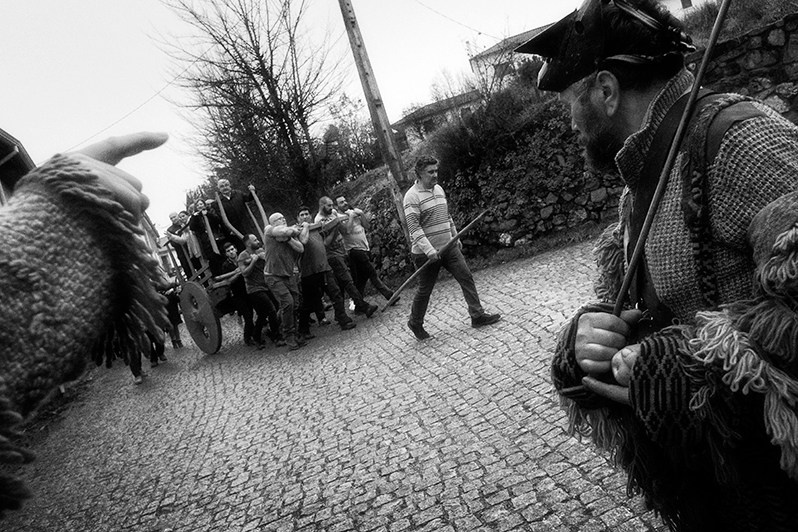 After the “Santo Estêvão” table, the boys place the “Mordomos” of the Festival and other local authorities on top of an ox cart pulled by themselves, Bragança municipality, Bragança district, Trás-os-Montes region, Portugal. 2022