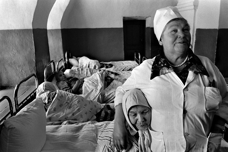 A nurse and patients at the Sviyazhsk Psychiatric Hospital, situated on the grounds of the Uspensky Monastery, Sviyazhsk Island, Zelenodolsk вistrict, Republic of Tatarstan, Russia. 1992 © Oleg Klimov