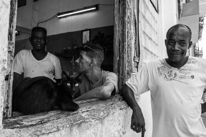 Three friends in one of Havana's central neighbourhoods, Centro Habana district, Havana, Cuba. 2017