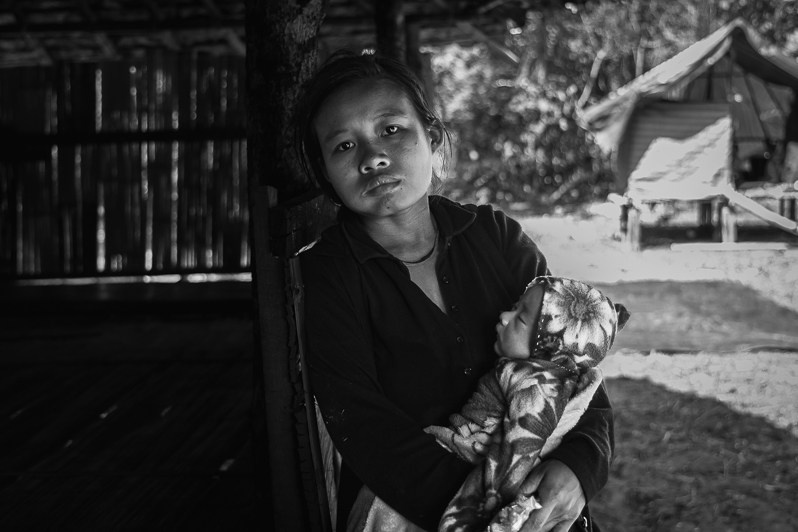 Karen displaced mother and her newborn child in a Kanele IDP camp near the Thai border, Way Lay, Myawaddy district, Kayin state, Myanmar. June 2022