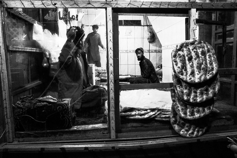 Freshly baked flatbread in a bakery working at night, Ghazni, Afghanistan. 2024