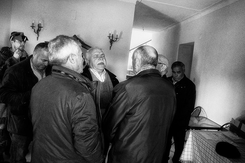 The singing of the “Reis” by the singers in the house of a villager under the watchful eye of “Careto”, Bragança municipality, Bragança district, Trás-os-Montes region, Portugal. 2019