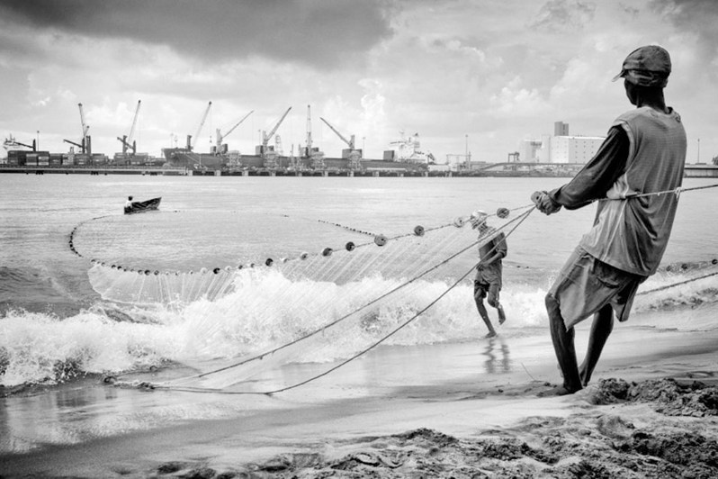 Small-scale fishing against a backdrop of an industrial port, Toamasina, Atsinanana region, Toamasina province, Republic of Madagascar. 2012