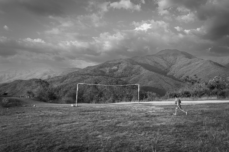 A boy playing football in the mountaneous region of Chin in Burma, Falam township, Chin state, Myanmar. May 2023