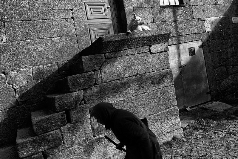 Woman strolls through shady alleys to avoid getting sunburned, Boticas municipality, Vila Real district, Trás-os-Montes region, Portugal. 2016