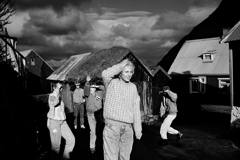 Teenagers playing football in sunset, Gjogv village, Nordoyar region, Faroe Islands, Kingdom of Denmark. 1987