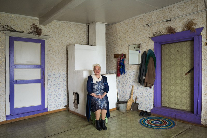 Maria Matveeva, former school teacher poses in her house, Bolshaya Puchkoma village, Udorsky district, Komi Republic, Russia. 2020