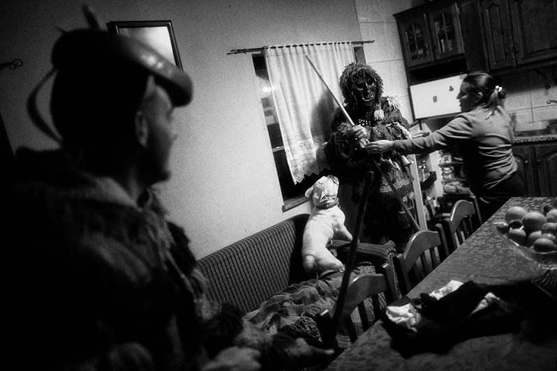 The “Caretos” try to steal some type of chorizo, Bragança municipality, Bragança district, Trás-os-Montes region, Portugal. 2019