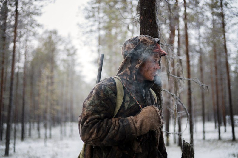 Anatoly Karpov, local hunter smokes in the forest during the hunt, near Makar-Yb village, Udorsky district, Komi Republic, Russia. 2018