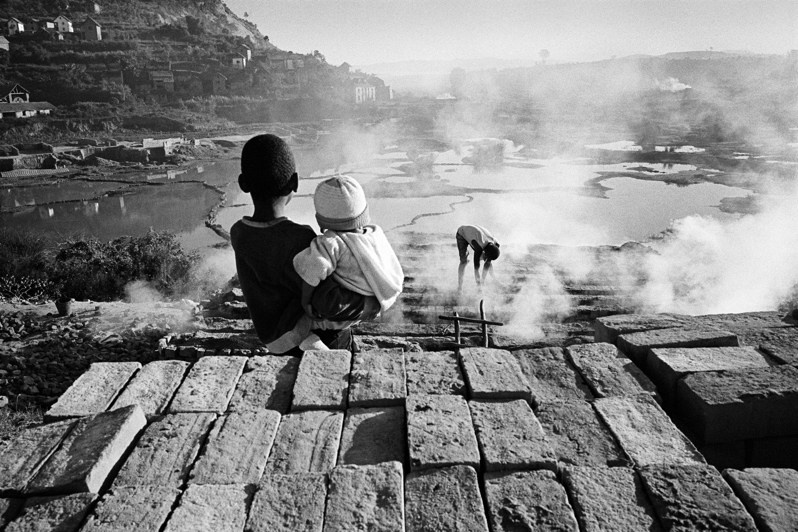 Children watching their father on a brick kiln, Fianarantsoa, Republic of Madagascar. 2011