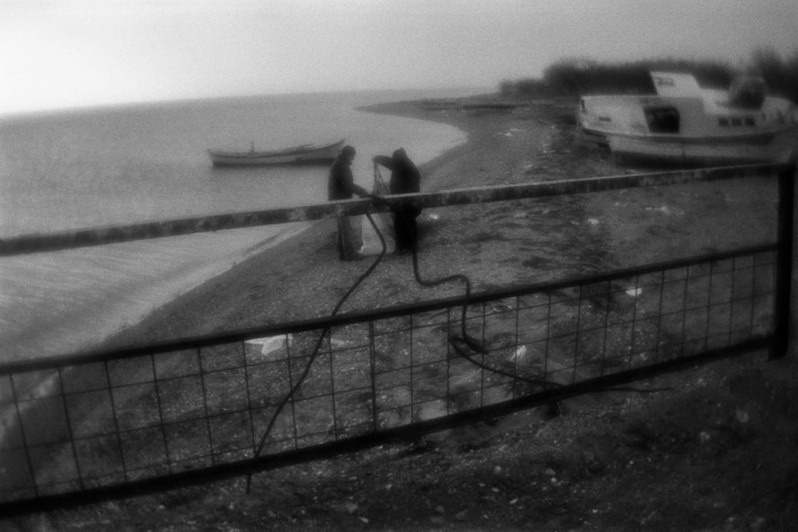 Fishermen are digging up the net they have hidden for safety, Çardak,  Denizli province, Turkey. January 2011