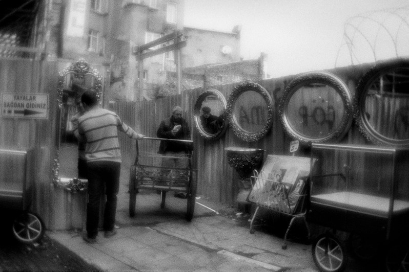 Mirrors hanged for the sale at the fence of the metro bridge construction site, Fatih district, Istanbul province, Marmara region, Turkey. January 2013