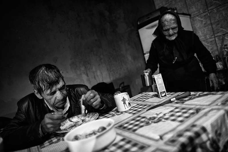 Mother takes care of her son at lunchtime, Montalegre municipality, Vila Real district, Trás-os-Montes region, Portugal. 2017