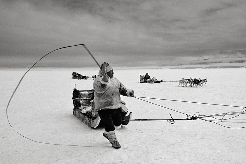 Masauna Kristiansen yells at dogs, Inglefield Fjord, Greenland, Kingdom of Denmark. 1987