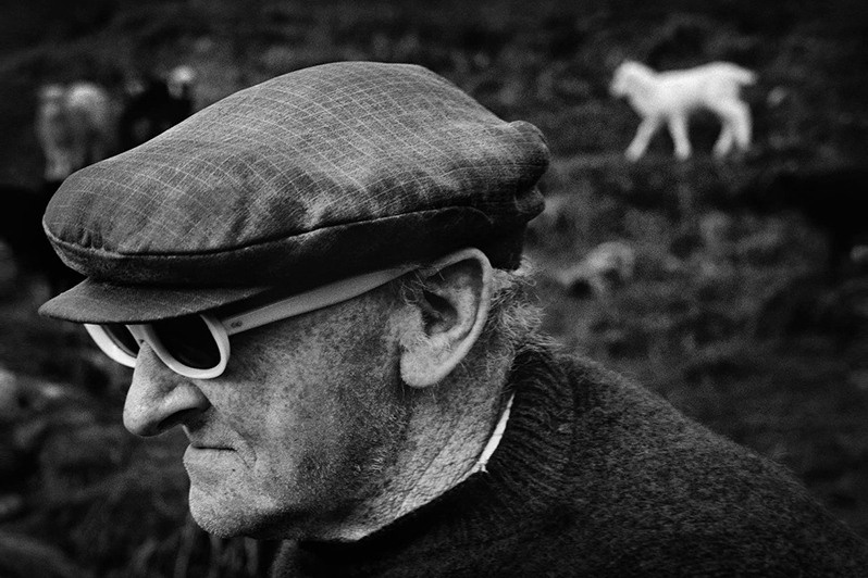 Rather too bright. Guttorm threw on a pair of yellow children’s sunglasses, Hattarvik village, Fugloyar municipality, Faroe Islands, Kingdom of Denmark. 1988