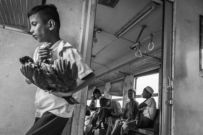 Rohingya minority travelling on the local train between the IDP camps, near Sittwe, Rakhine state, Myanmar. September 2019