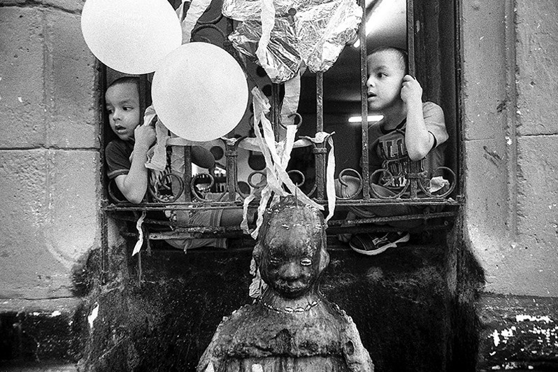 Two brothers from Jimagua. Celebrating the birthday of Elegua, deity of the Yoruba religion, Los Sitios neighbourhood, Centro Habana district, Havana, Cuba. 2023